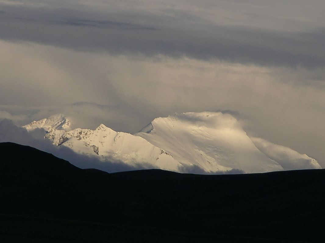 Shishapangma North 01 03 Labuche Kang From Shishapangma Checkpoint After dinner, I noticed a large white mountain glistening in the evening sun. I used binoculars and pleasantly discovered it was Labuche Kang (7367m, also called Lobuche Kang I or Choksiam). The first ascent of Labuche Kang was by a Chinese-Japanese team led by Yamamori that succeeded in 1987 after a first exploration carried on the year before.